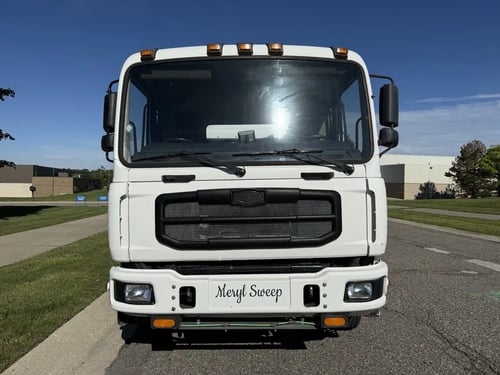 Front view of a used 2013 Elgin Whirlwind street sweeper on an Autocar Xpeditor chassis.
