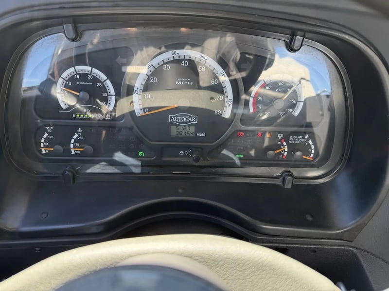 Instrument cluster and odometer of a 2013 Elgin Whirlwind street sweeper showing approximately 38,154 miles.