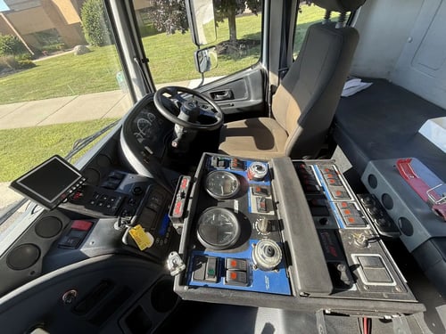 Operator control panel and dashboard inside a 2013 Elgin Whirlwind regenerative air street sweeper.