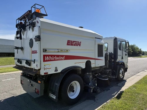 Rear right angle of a used 2013 Elgin Whirlwind regenerative air street sweeper.
