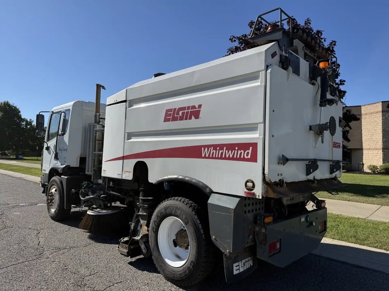 Rear left view of a used 2013 Elgin Whirlwind regenerative air street sweeper.