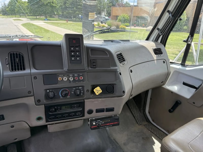 Center dashboard transmission selector and operator controls inside the 2006 Vactor 2100.