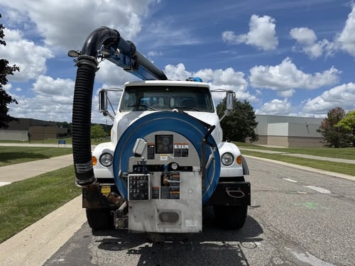 Front view of the 2006 Vactor 2100 highlighting the front hose reel boom and operator control station.