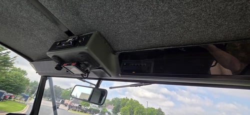Overhead console inside a 2015 Elgin Pelican NP Dual street sweeper.