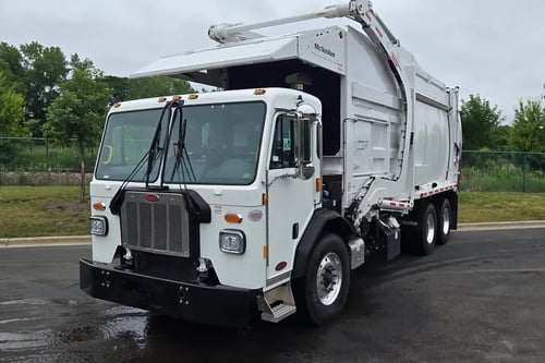 Front driver side angle of 2026 McNeilus Atlantic Commercial 40 yard front loader truck