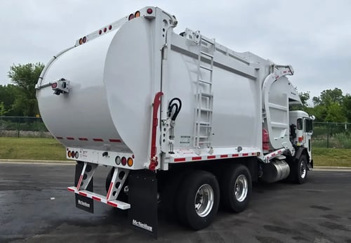 Rear passenger side angle of 2026 McNeilus Atlantic Commercial 40 yard front loader garbage truck