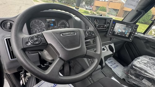 Driver cockpit and steering wheel inside Vactor 2100i PD