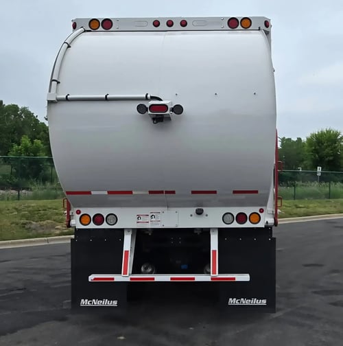 Rear view of a McNeilus Atlantic 40-yard front load garbage truck.