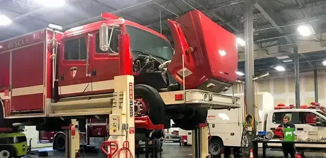 Ambulance undergoing chassis service during the remount process at a dedicated remount facility, extending EMS vehicle lifespan through refurbishment and mechanical upgrades.