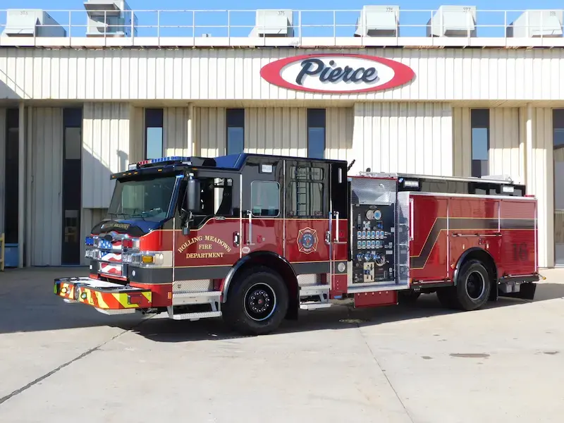 Pierce pumper fire engine with a midship pump panel, equipment compartments, and custom chassis.