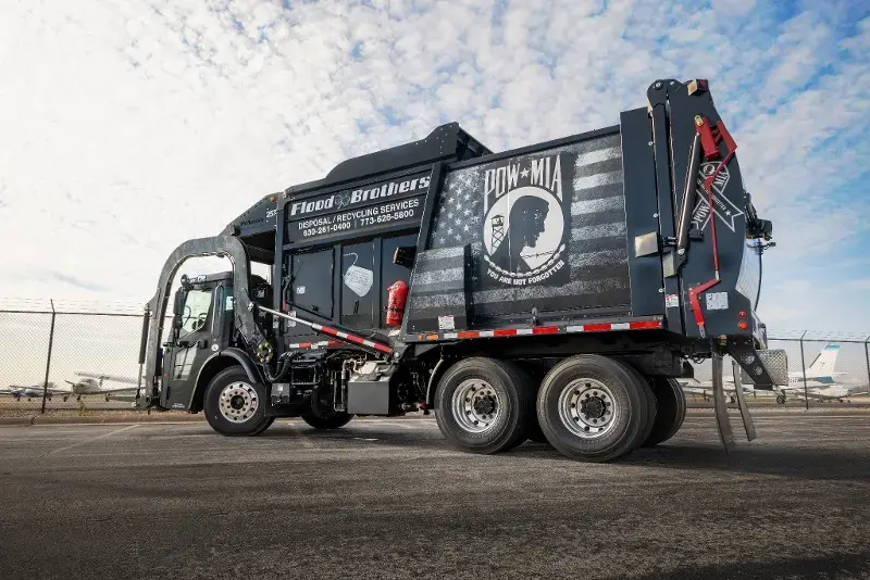 McNeilus rear-loader refuse truck used for commercial waste collection and recycling services, delivering reliable sanitation and environmental solutions.