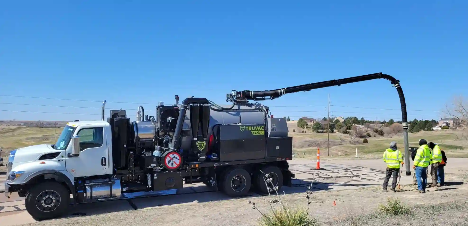 TRUVAC FLXX hydro excavation truck actively excavating soil, using pressurized water and vacuum technology for precise, non-destructive utility exposure.