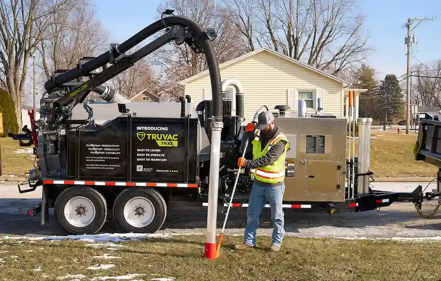 Operator using a TRUVAC TRXX hydro excavator in the field, performing precise excavation work with advanced vacuum technology and efficient debris removal.