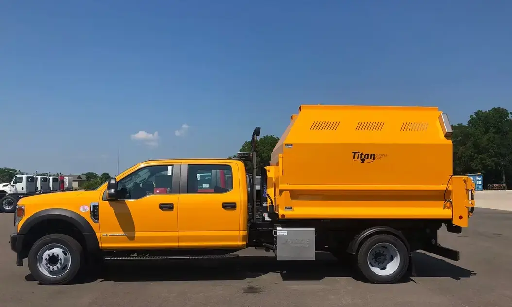Titan leaf collection container mounted on a truck, featuring high-capacity debris storage designed for efficient leaf pickup and seasonal cleanup operations.