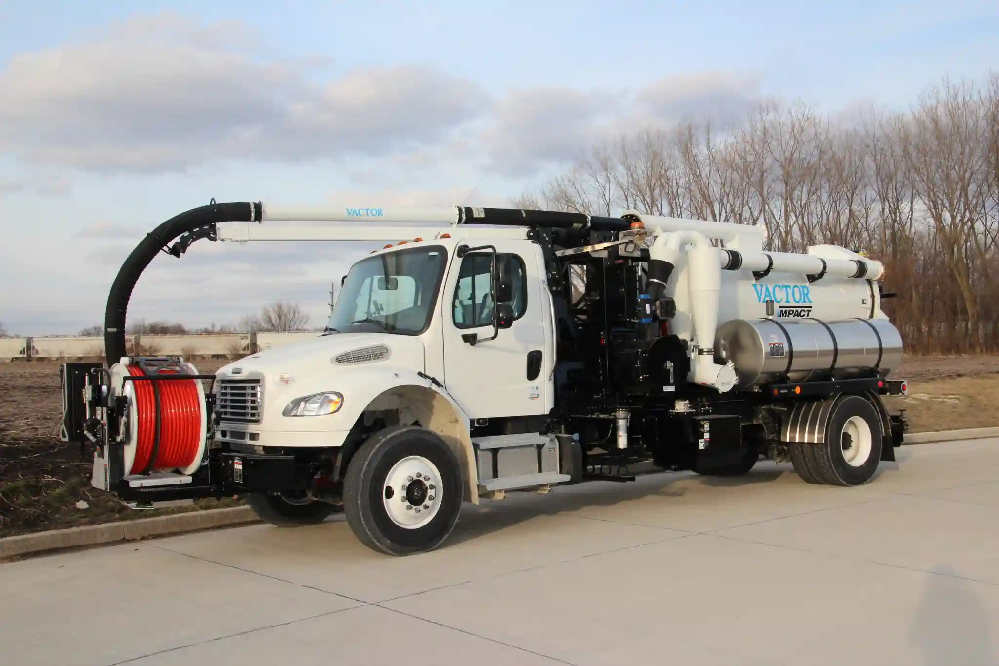 Vactor iMPACT combination sewer cleaner positioned outdoors, highlighting its compact design, vacuum system, and water jetting capabilities for wastewater maintenance operations.