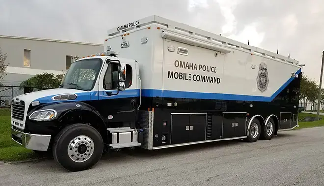Large police mobile command vehicle equipped for incident management, communications, and field operations support.