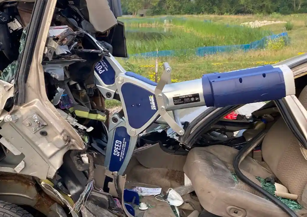 Hurst hydraulic rescue tool deployed inside a damaged vehicle, demonstrating extrication equipment used by emergency responders during vehicle rescue operations.